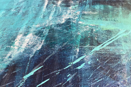 section of blue green painting with splatters of paint